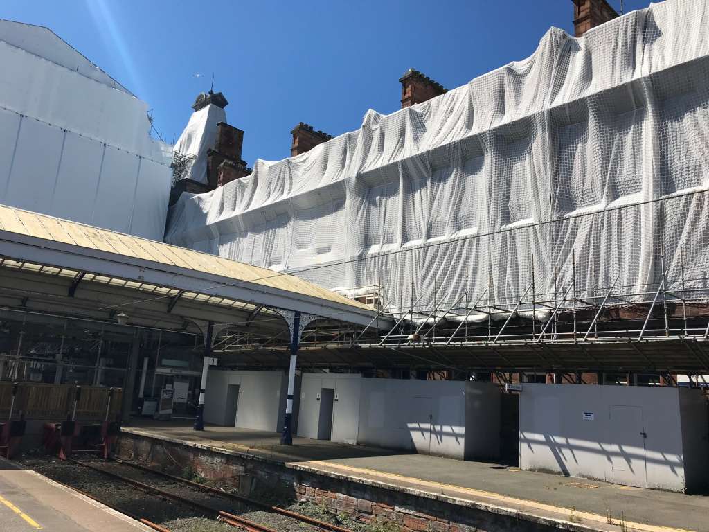 Abandoned by its owner, the station hotel is now cocooned in protective plastic (Credit: NR)