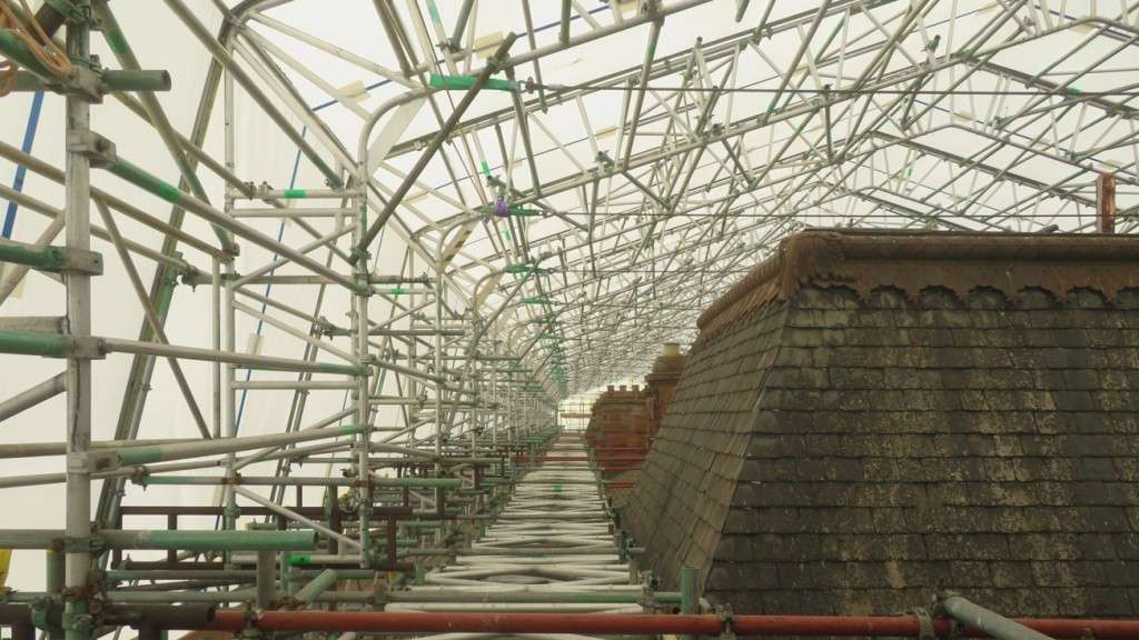 The South Range roof has been protected from the weather by the scaffolding encapsulation [Credit TM