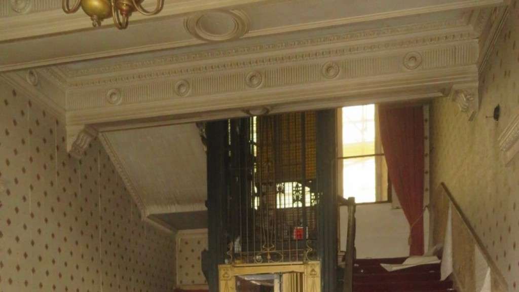 The grand staircase in the south wing in June 2023 with what could be the original lift of 1885 [Cre