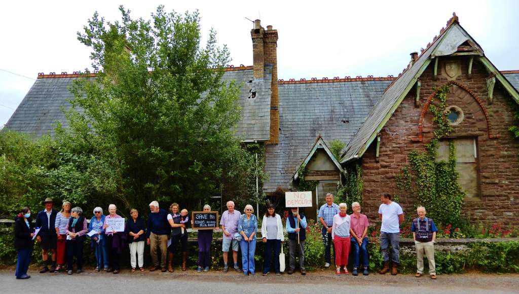 Residents of Garway gather outside the Old School in protest of its demolition. 